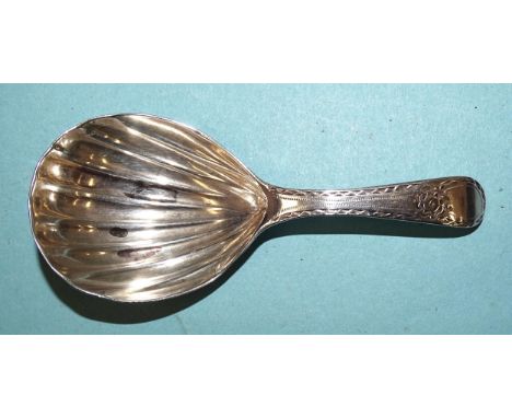 A George III caddy spoon with bright-cut handle and shell bowl, London 1789. 