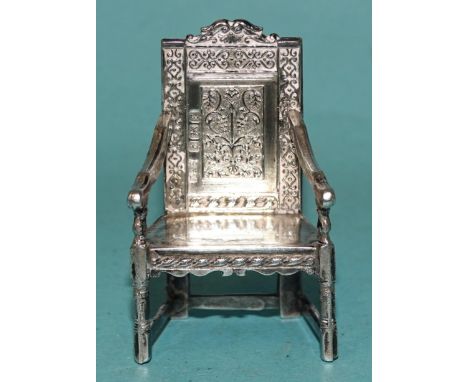 A miniature model of a Wainscot chair, Birmingham 1905, by Levi &amp; Salaman, reg. no. 598779, 4.5cm high. 