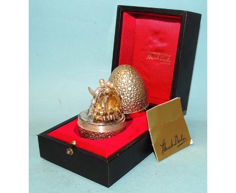 Stuart Devlin, a silver gilt surprise egg, the cratered egg opening to reveal a humming bird, London 1977, no.7 of 300, in bo