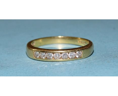 An 18ct gold ring channel-set seven brilliant-cut diamonds, total diamond weight approximately 0.35cts, size R, 4.3g. 