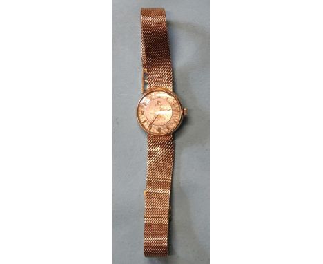 Omega, a lady's 1950's 18ct gold-cased wrist watch, with signed silvered dial and gilt 3, 6, 9 and 12 on textured ring, the c