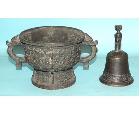 An Asian bronze bowl of Indo-Chinese style, 23cm diameter and a later metal hand bell, (2). 