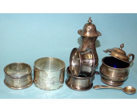 A heavy-gauge silver napkin ring, Sheffield 1949, (boxed), three other silver napkin rings and two silver cruet items, total 