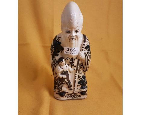 Early 20thC Stoneware Figure of a bearded Chinese Figure with child at foot, blue flowers on cloak, 27cm high