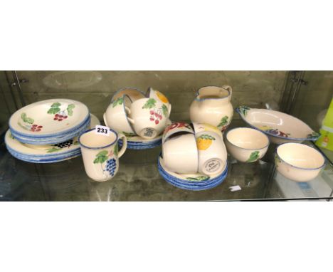 SHELF OF POOLE DESIGN TEACUPS AND SAUCERS