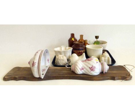 Collection of pottery jelly moulds, four stoneware bottles, miniature set of scales, a continental pottery wall mounted ciste