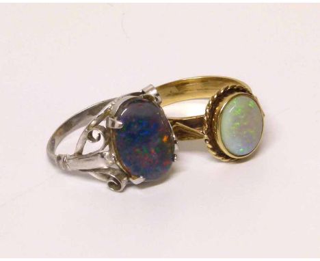 Oval green blue and red coloured opal in white metal setting and another opal set in 9ct yellow gold ring. Condition report: 