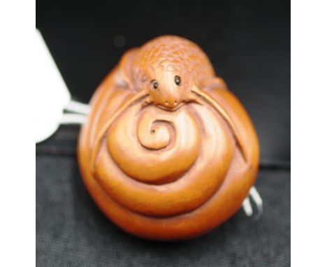 Japanese carved timber netsuke of a coiled serpent signed to base, 5cm high.