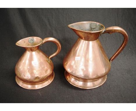 Two Georgian copper jugs including a W R Loftus half gallon jug and a quart jug, some minor dings, height 22cm approx (talles