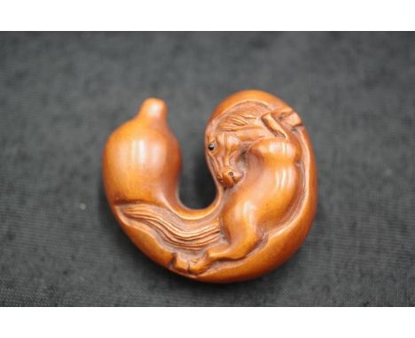 Japanese carved timber netsuke of a horse signed to base, 5cm high.