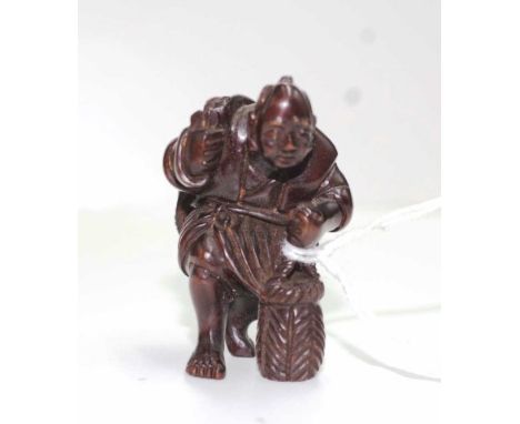Antique Japanese carved timber netsuke of a man with bags. Signed to foot.