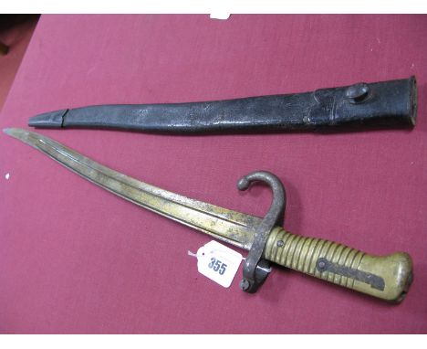 A Mid XIX Century French Chassepot Sabre Bayonet of 1866, the recurving blade is engraved with makers name and dated 1872 wit