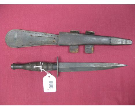 Mid XX Century Fairburn Sykes Fighting Knife, Sheffield Maker, blade and cross guard lightly pitted, in its correct brown lea
