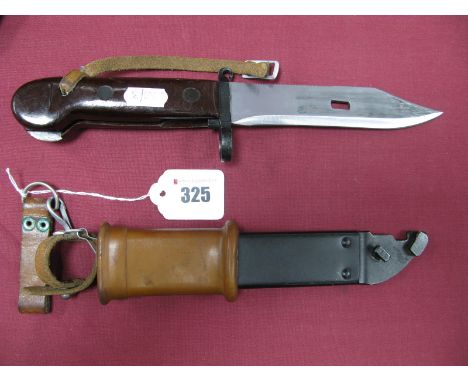 A Mid to Late XX Century Russian AK47 Knife Bayonet, with part serrated edge, in its metal and plastic scabbard.