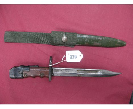 A XX Century British No 7 Bayonet With Swivelling Hilt, with a 8" long Bowie blade and red plastic grips, in its green painte