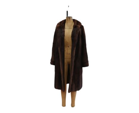 A vintage fur coat bearing a label of the Dominion Fur Co Ltd of Church Hill, Edinburgh, late 20th Century