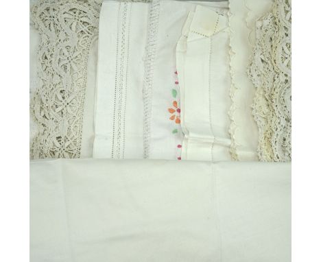 A large quantity of vintage linen and whitework tablecloths 