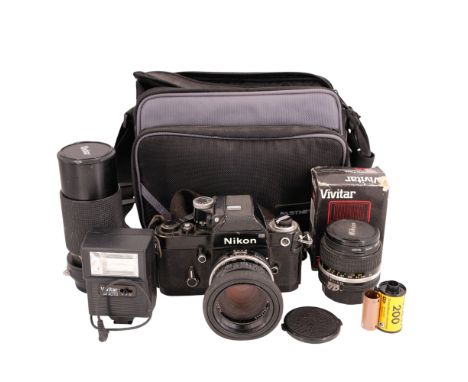 A 1970s Nikon F2 Photomic camera, serial number 7715284, together with Nikon Nikkor 28 mm 1:2.8 and Vivitar 70-210 mm 1:4.5 l