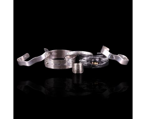 Four various silver / white metal bangles including an adjustable engine-turned cuff bangle, together with a Swatch "flange" 