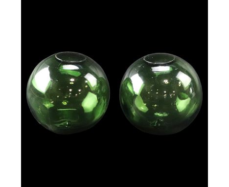 Two vintage green glass fishing floats marked "FGC", approximately 13 cm