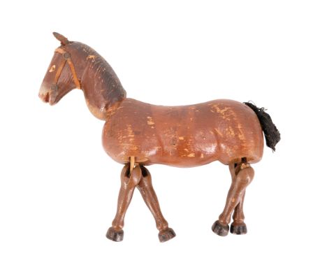 A vintage carved and painted articulated toy horse, circa mid-20th Century, 20 cm