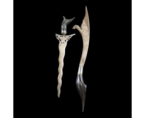 A Malayan horn-handled white metal paper knife in the form of a miniature kris dagger, together with a similar knife, circa s