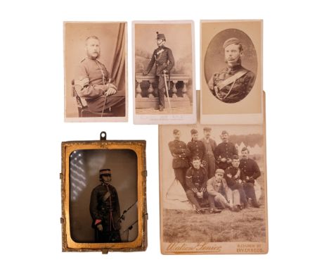 A Victorian tinted ambrotype photographic portrait of a Scottish Forfar Rifle Volunteer, together with three military cartes 