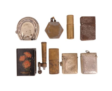A Howell James &amp; Co wind-up wick and match cigarette lighter of horseshoe form, together with trench art rifle cartridge,