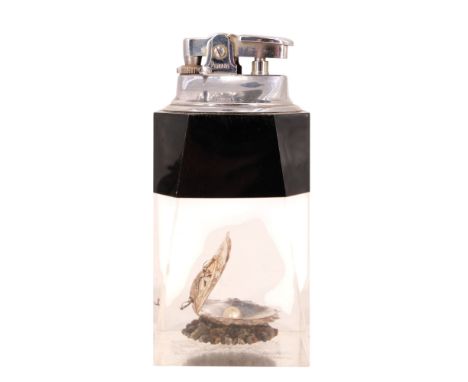 A 1960s kitsch Penguin table lighter its faceted lucite body containing a oyster shell and pearl, 11 cm 