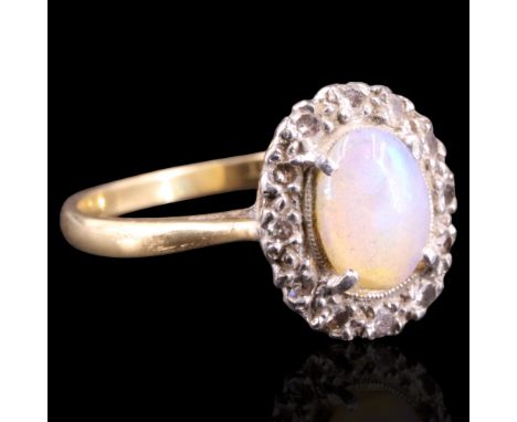 A vintage opal and diamond ring, comprising an oval opal cabochon of approx 8 mm x 6 mm claw-set above a fine beaded platinum