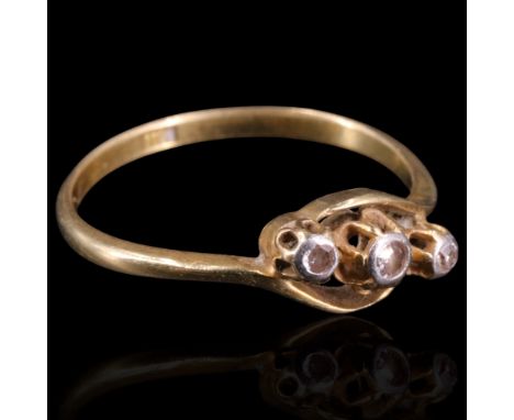 A vintage twist-set three-stone diamond ring, the small old cut stones platinum bezel set on an 18 ct gold shank, Q, 2 g