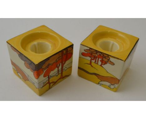 A pair of Clarice Cliff Coral Firs pattern, hand painted pottery cube form candle holders, pattern number 658, bear Clarice C