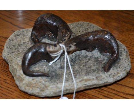 Stone carving of three otters mounted on a plinth of flat rock Base 12cm x 10cm Condition is good.  