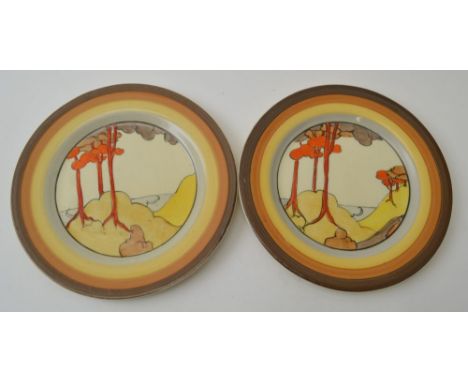 A pair of Clarice Cliff Coral Firs pattern, circular hand painted pottery tea plates, 15cm diameter, each with printed factor