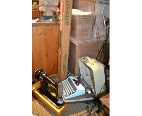 Cased typewriter cased sewing machine and a projector screen