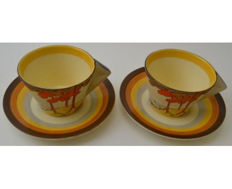 A pair of Clarice Cliff Coral Firs pattern teacups and saucers, conical cups with filled in angular handles, hand painted pot