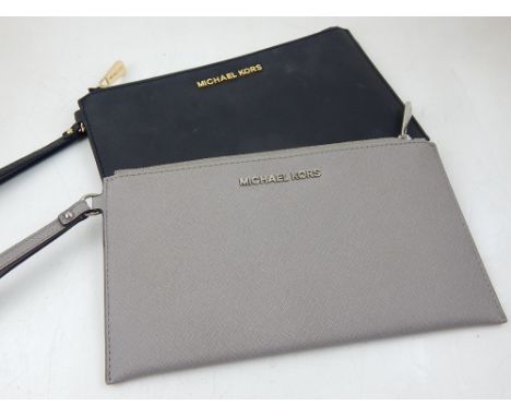 A Michael Kors ladies black leather clutch, together with one light grey clutch of similar design.