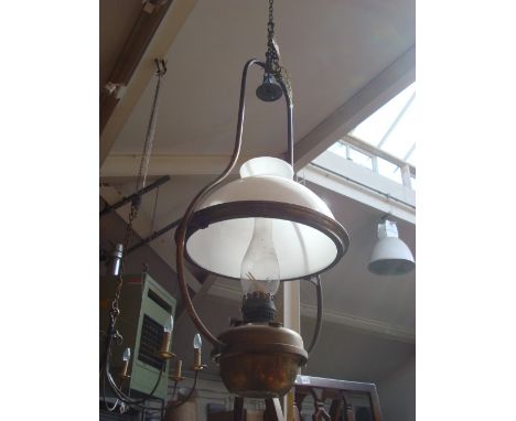 A Victorian brass hanging lamp with shade and original burner, fitted for electricity.