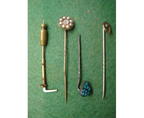 Three yellow metal stick pins and another. 