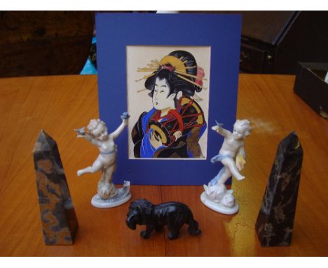 Two small marble obelisks, two Continental porcelain figures, a small soapstone lion, a Chad valley miniature bagatelle. 