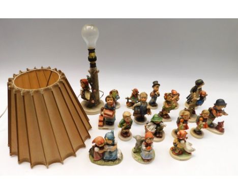 Goebel: a good collection of M.J. Hummel figurines including a lamp and shade of a little girl sitting on a tree in bloom, pu