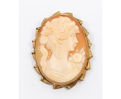 A vintage 9ct gold mounted cameo brooch, comprising a shell carved cameo depicting a female bust, within a gold mount with ro