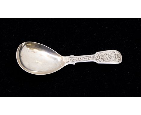 A Victorian silver fiddle pattern caddy spoon, the handle engraved with swirling foliage, with banner with initials, hallmark