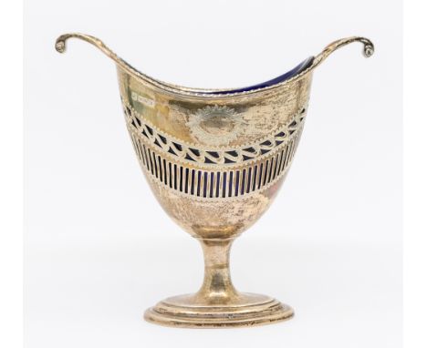 A George V pierced silver sugar basket, of helmet form with scrolled handles, oval footed base and vacant cartouche to front.