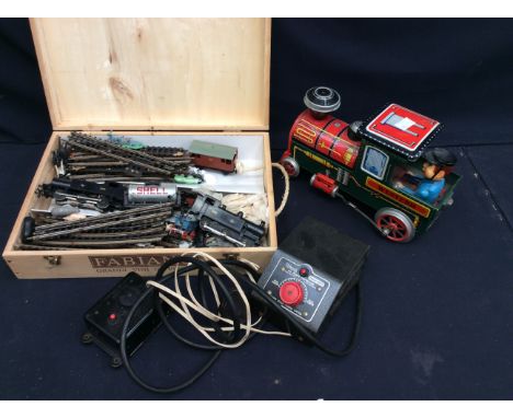 Collection of vintage train items, including tin plate and small train set.
