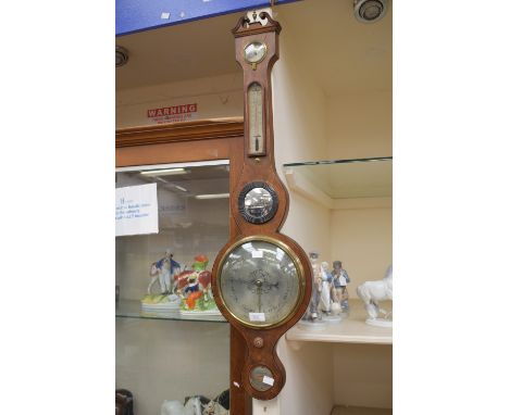 An A. Maspoli of Hull burr walnut cased barometer, with inlayed detail.
