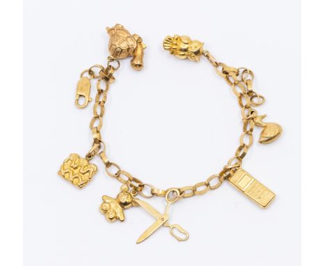 A 9ct gold charm bracelet, suspending various 9ct gold and yellow metal charms, including Owl, cell phone, scissors, turtle, 