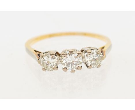 A three stone diamond and 18ct gold ring, comprising three graduated round brilliant cut diamonds, total diamond weight appro