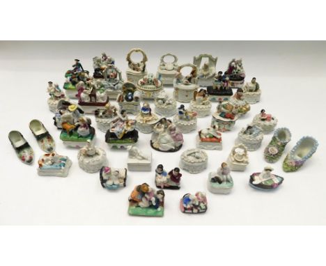 A large collection of late 19th century Continental porcelain trinket boxes with figure details on the lids