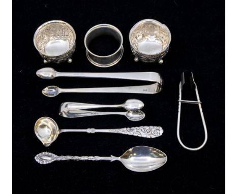 A small collection of silver to include; a pair of Victorian silver circular salt pots, having four ball feet, embossed folia